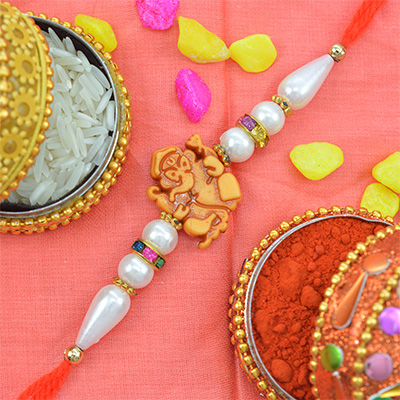 Alluring Golden Ganesh Rakhi with Graceful Pearls