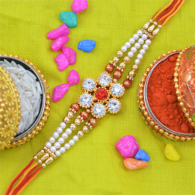 Fascinating Flower Shape Diamonds and Jewel Pearl Rakhi with Colorful Thread