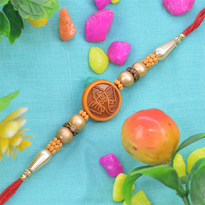 Graceful Rounded Ganesh Pearl Rakhi with Beautiful Beads in Thread