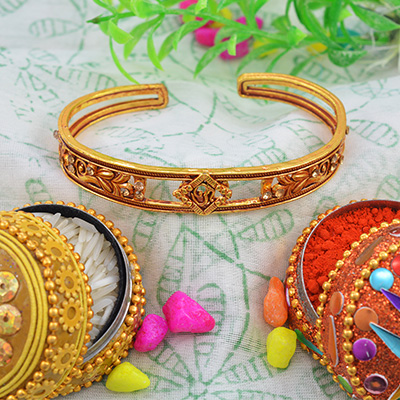 Marvelous Golden OM Rakhi Bracelet with White Diamonds