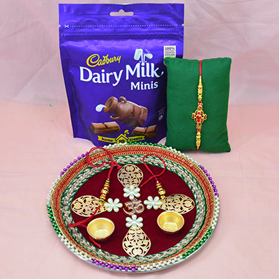 Divine Om in Mid Maroon Base Amazing Looking Rakhi Puja Thali with Dairy Milk Minis