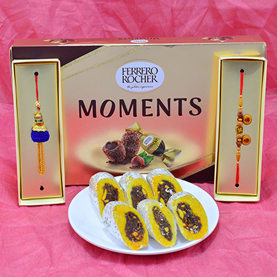 Eye Catching Sandalwood Bhaiya Bhabhi Rakhi with succulent Kaju Rajbahar and Tasteful Ferrero Rocher Moments