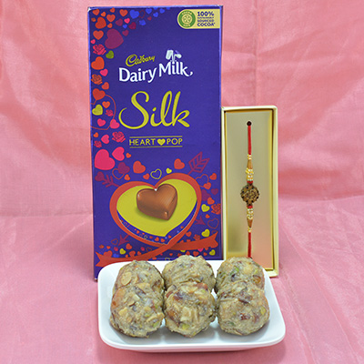 Flavorful Dry Fruit Laddu with Delicious Dairy Milk Silk along with Attractive Rakhi Hamper