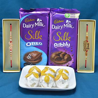 Mouthwatering Kaju Badam Laddu with Luscious Cadbury Dairy Milk Silk Chocolates along with 2 Rakhi Pcs Hamper