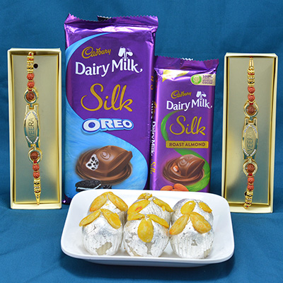 Piquant Kaju Badam Laddu with Delicious Cadbury Dairy Milk Silk Chocolates along with Rich Look Veera Printed Rakhi Hamper
