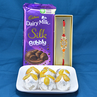 Finger Licking Cadbury Dairy Milk Silk Bubbly with Mouthwatering Kaju Badam Laddu along with Diamond Jewel Beads Rakhi Hamper