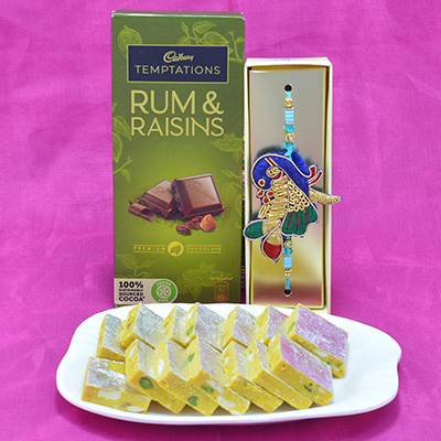 Piquant Kaju Kesar Pista Barfi with Appetizing Cadbury Temptations along with Stunning Mayur Zardosi Rakhi Hamper