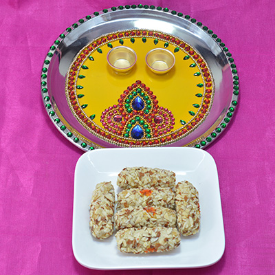 Piquant Kaju Butterscotch Roll with Illustrious Multicolor Jewel Pooja Thali Hamper
