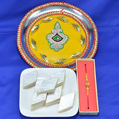 Gorgeous Yellow Base Deepak Crafted Pooja Thali with Piquant Kaju Katli along with Sandalwood Rakhi