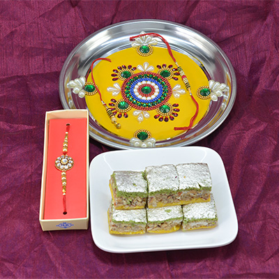 Wonderful Flower Design Crafted Pooja Thali with Delicious Badam Pista Barfi along with Diamond Jewel Rakhi