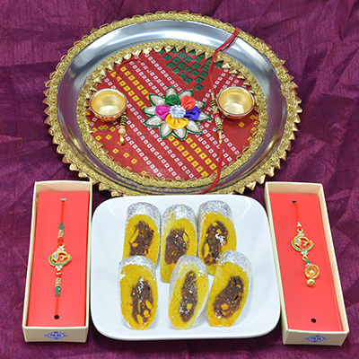 Awesome Flower Design Pooja Thali with Delicious Kaju Rajbahar Sweet along with Bhaiya Bhabhi Rakhi Hamper