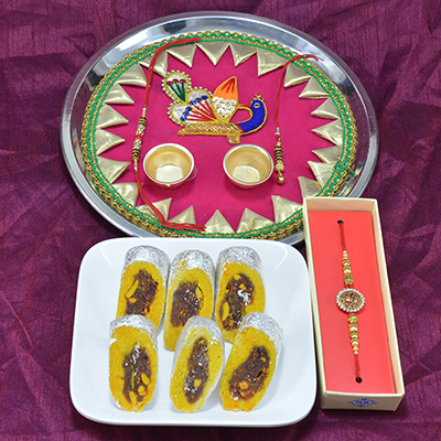 Marvelous Peacock Design Pooja Thali with Luscious Kaju Rajbahar along with Diamond Jewel Rakhi