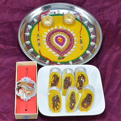 Amazing Yellow Base Painted Colorful Beads Pooja Thali with Savory Kaju Rajbahar Sweet along with Kids Rakhi