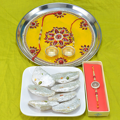 Astounding Flower Design Pooja Thali with Tasteful Kaju Gujia along with Brother Rakhi