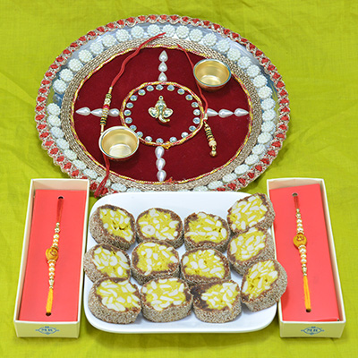 Savory Kaju Anjeer Pista Barfi along with Divine Ganesha Crafted Pooja Thali with Sandalwood Beads Rakhi