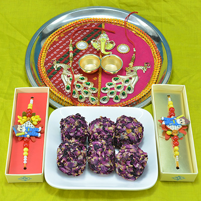 Astounding Traditional Divine Crafted Pooja Thali with Savory Kaju Rose Laddu along with Kids Rakhi