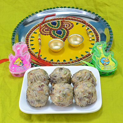 Spectacular Beads Crfted Pooja Thali with Luscious Kaju Dry Fruit Laddu along with Kids Guitar Rakhi