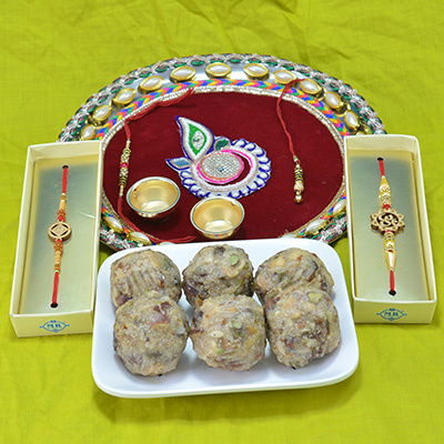 Succulent Kaju Dry Fruit Laddu with Beautifully Crafted Pooja Thali and 2 Types of Gorgeous Rakhi 