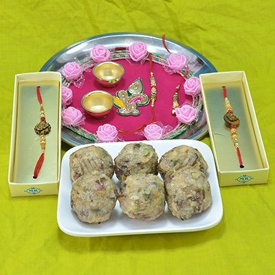 Magnificent Flower Design Pooja Thali with Luscious Kaju Dry Fruit Laddu along with Golden Beads Rakhi 