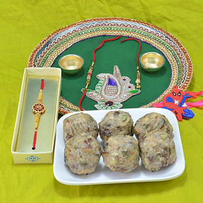 Savory Kaju Dry fruit Laddu with Stunning Crafted Pooja Thali along with Divine Sandalwood and Kids Spidermen Rakhi