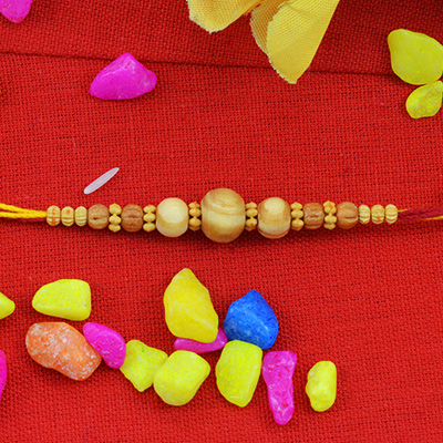 Antique and Rich Looking Sandalwood Beads Rakhi with Fascinating Dori