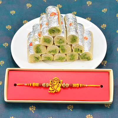 Appetizing Sandalwood Golden Ganesha Beads Rakhi with Luscious Kaju Pista Roll Hamper