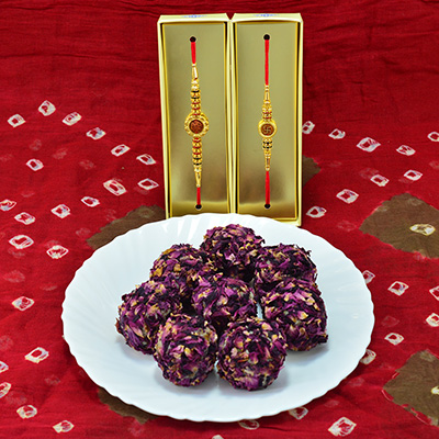 Magnificent Divine Golden Theme Rakhi with Piquant Kaju Rose Laddu