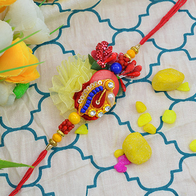 Graceful Zardozi Rakhi with Unique Yellow Flower Design along with Attractive Beads