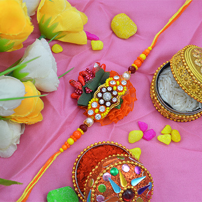 Awesome Zardosi Rakhi with Bright Rich Looking Pearls with Soft Colorful Dori
